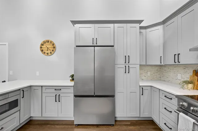 a view of a house with a big yard and large trees