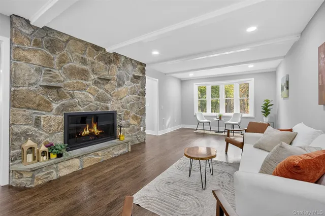 a kitchen with stainless steel appliances granite countertop a sink a stove a refrigerator cabinets and a window