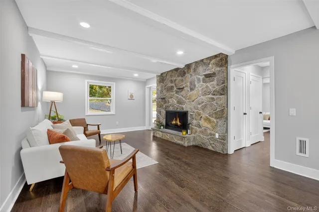 a living room with a bed furniture and a window
