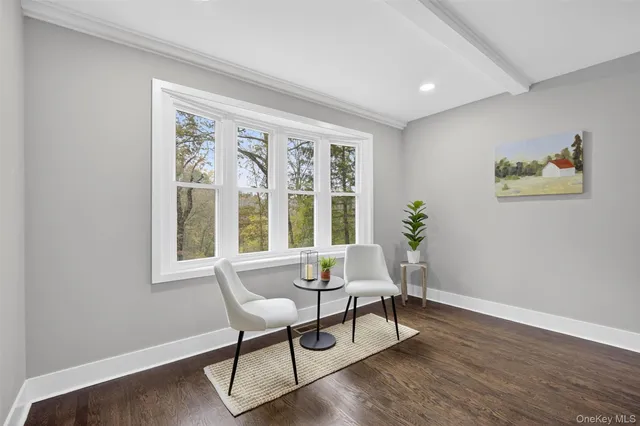 a bedroom with a bed and painting on the wall