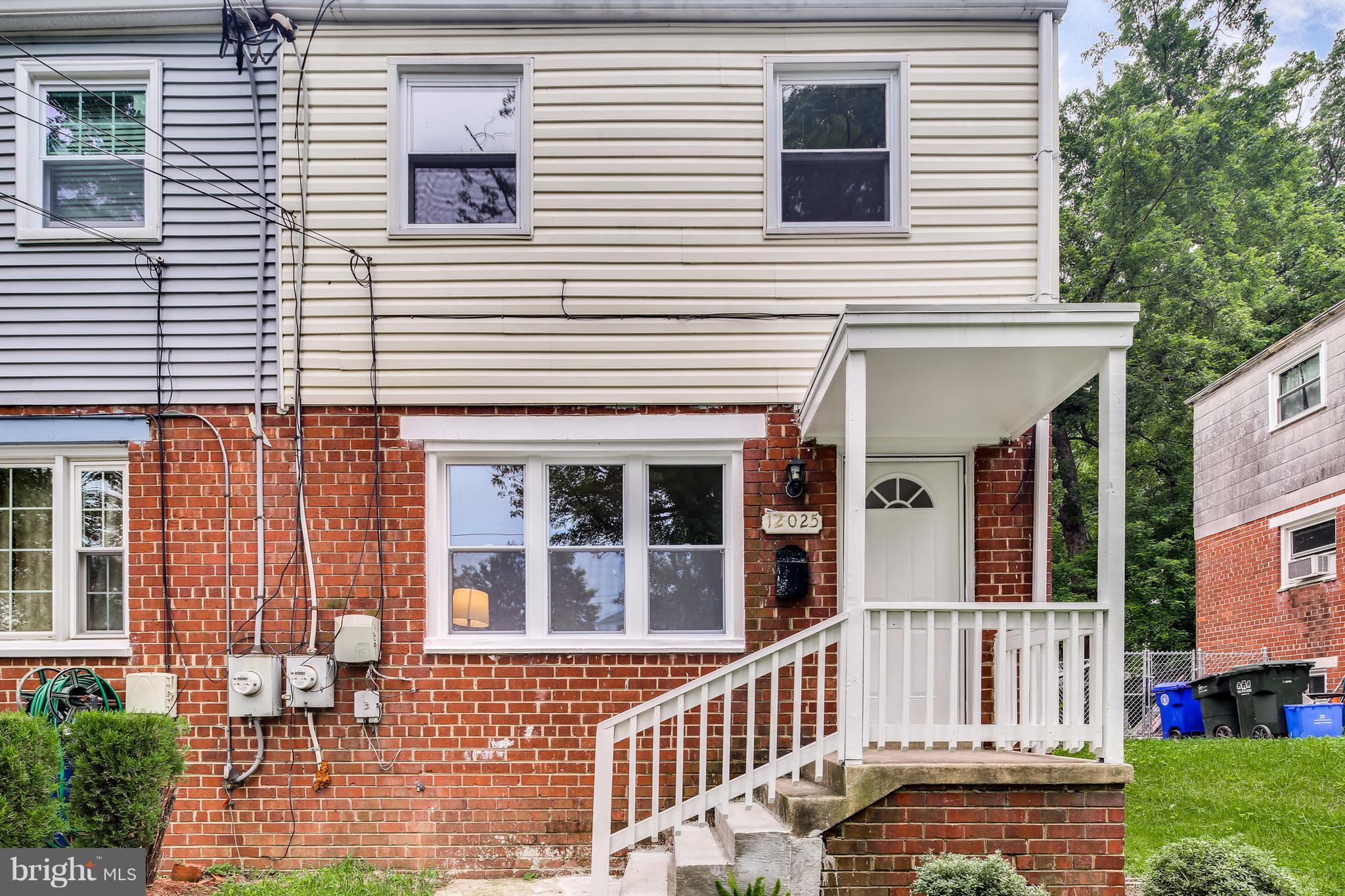 12025 Berry Street Silver Spring, MD 20902 - Photo 1 of 19 a view of a house with a small yard and wooden floor and fence