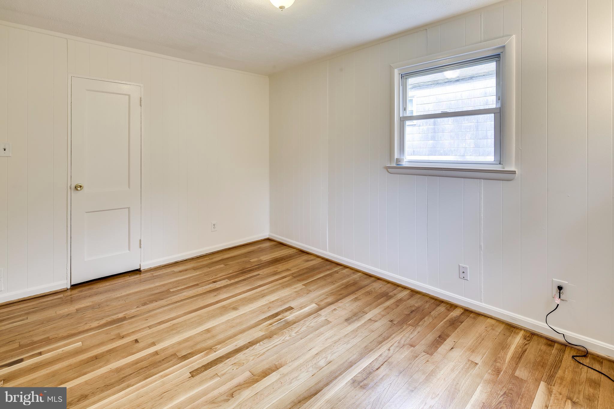 12025 Berry Street Silver Spring, MD 20902 - Photo 11 of 19 a view of empty room with wooden floor and fan