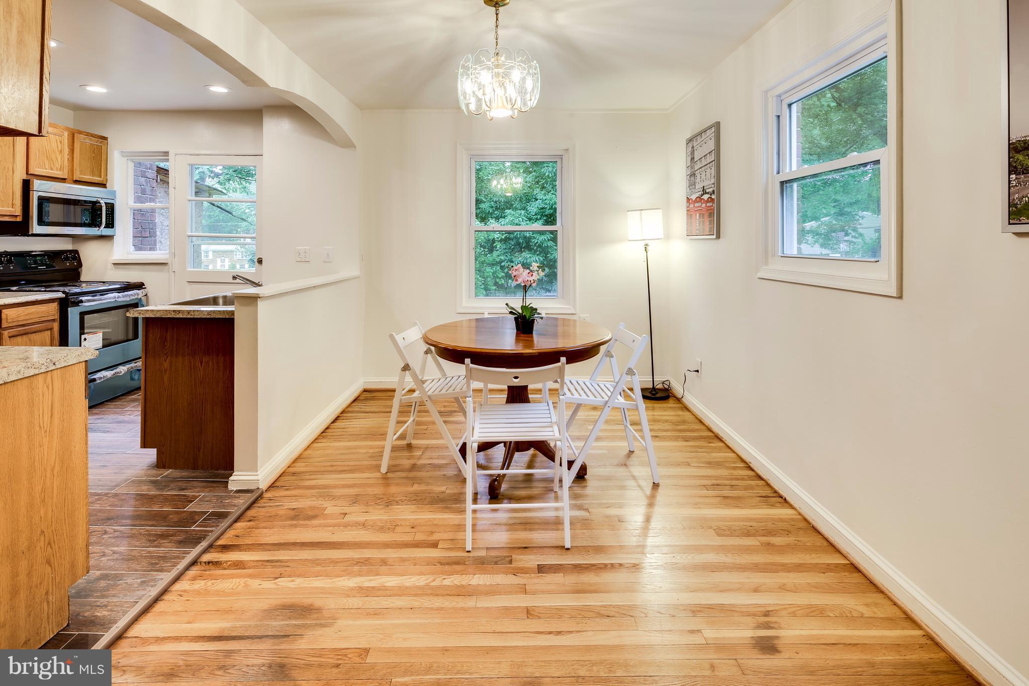 12025 Berry Street Silver Spring, MD 20902 - Photo 5 of 19 a view of a dining room with furniture window and wooden floor