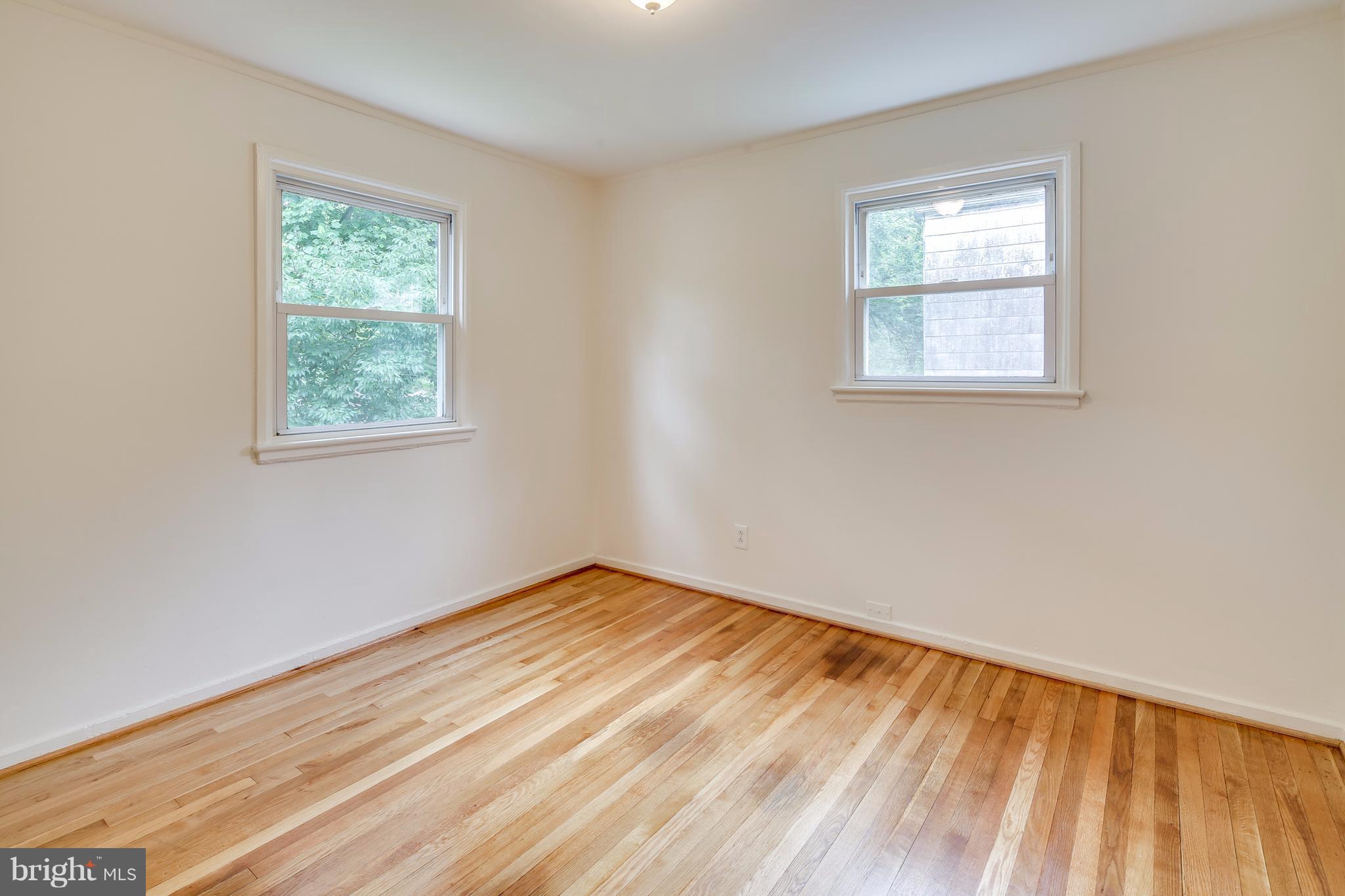 12025 Berry Street Silver Spring, MD 20902 - Photo 9 of 19 a view of an empty room with wooden floor and a window