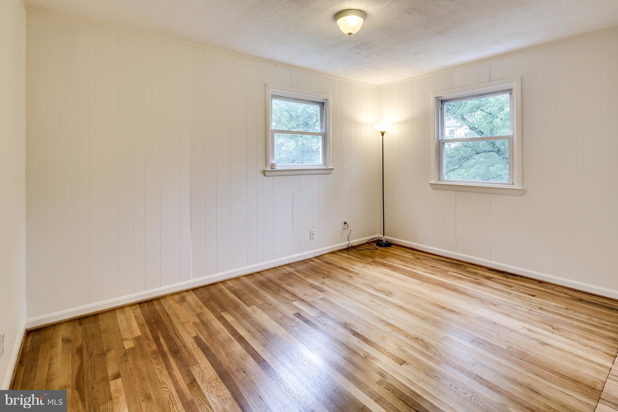 12025 Berry Street Silver Spring, MD 20902 - Photo 10 of 19 an empty room with wooden floor and windows