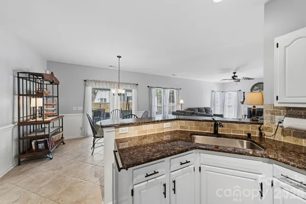 a kitchen with granite countertop a sink and a stove