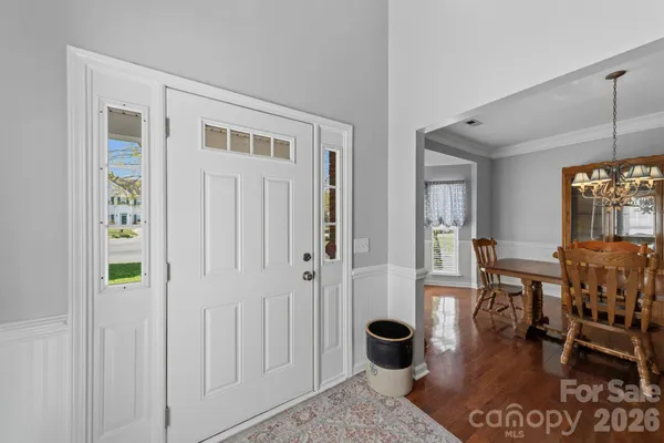 a dining room with furniture and wooden floor