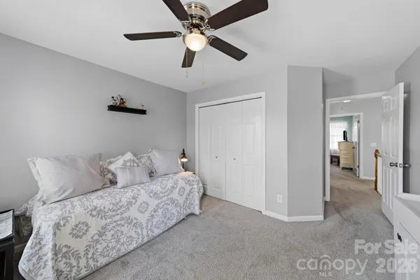 a living room with furniture and a ceiling fan