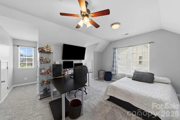 a bedroom with a large bed and a flat screen tv