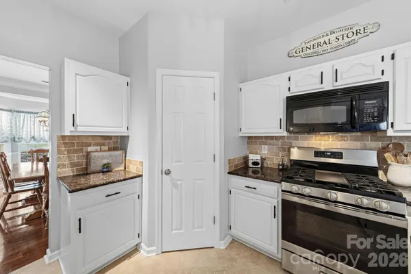 a kitchen with stainless steel appliances a stove a microwave and sink