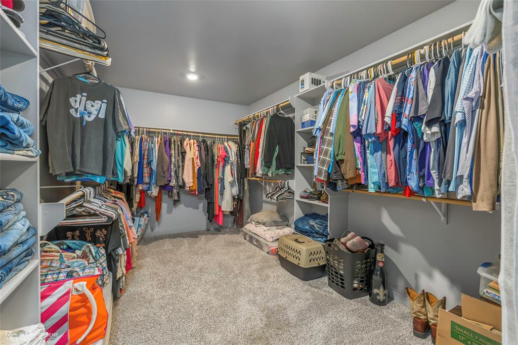 396 Collinswood Road Stonewall, LA 71078 - Photo 28 of 32 a view of walk in closet with clothes