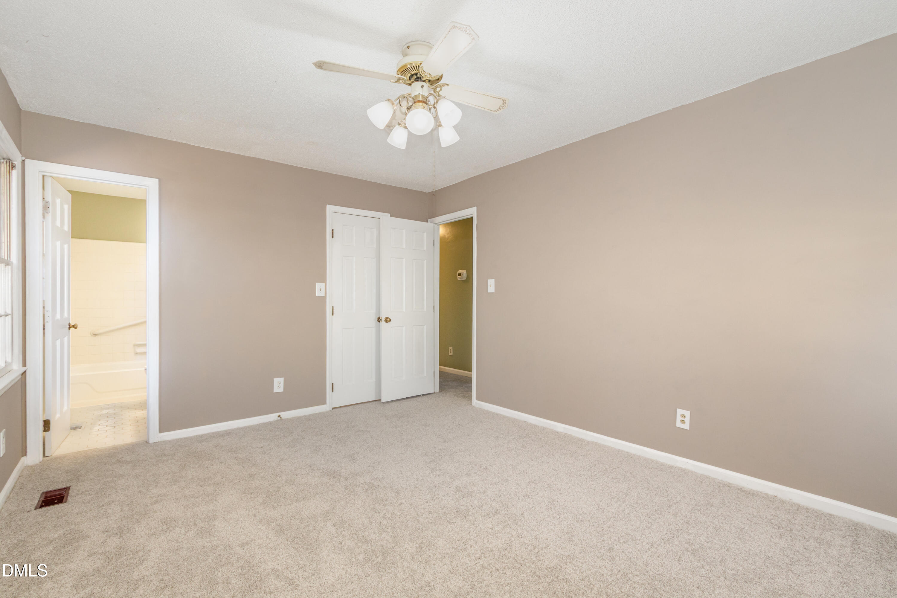 6800 Valley Drive Raleigh, NC 27612 - Photo 17 of 35 an empty room with chandelier fan and windows
