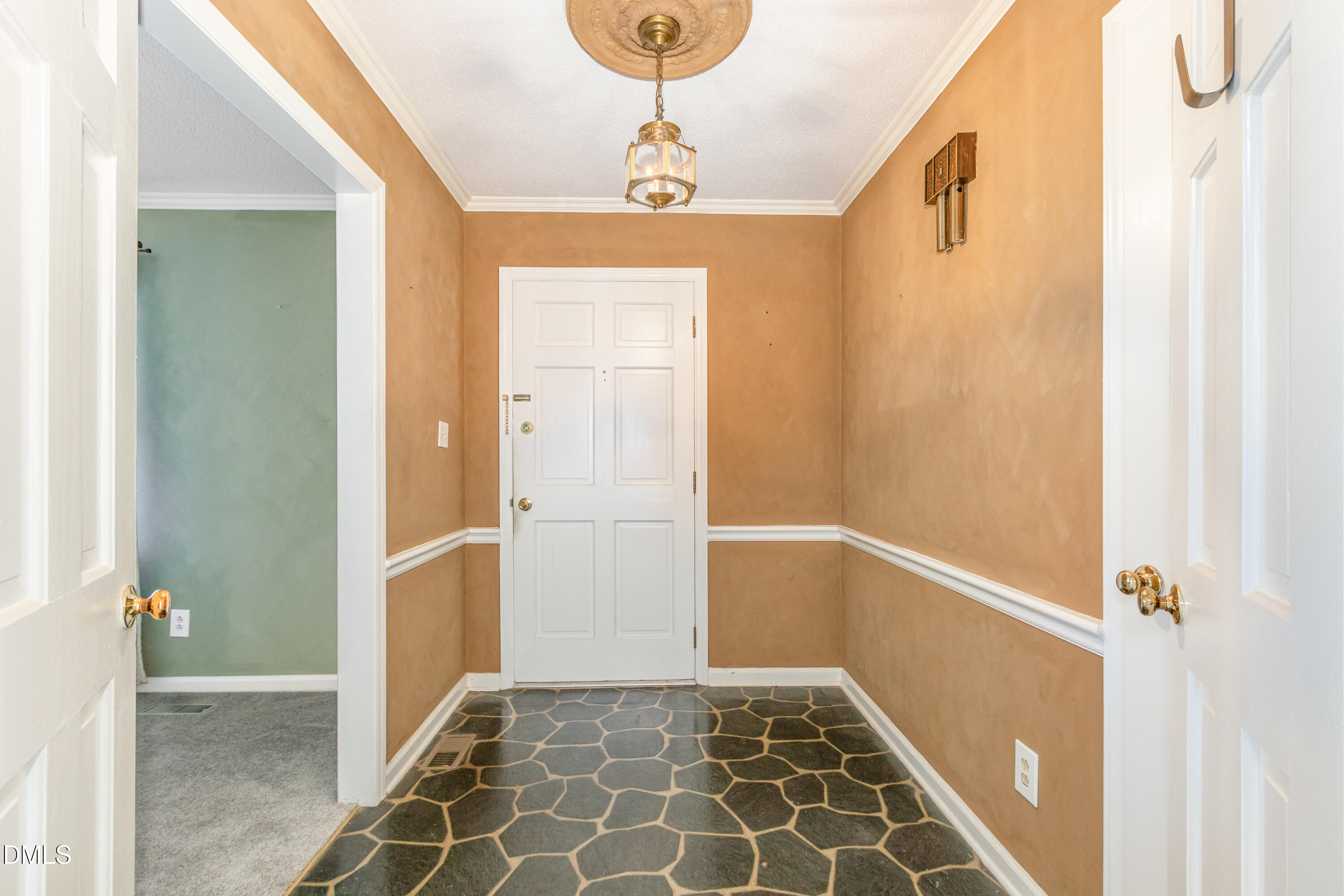 6800 Valley Drive Raleigh, NC 27612 - Photo 6 of 35 a view of a hallway with wooden floor and a bathroom