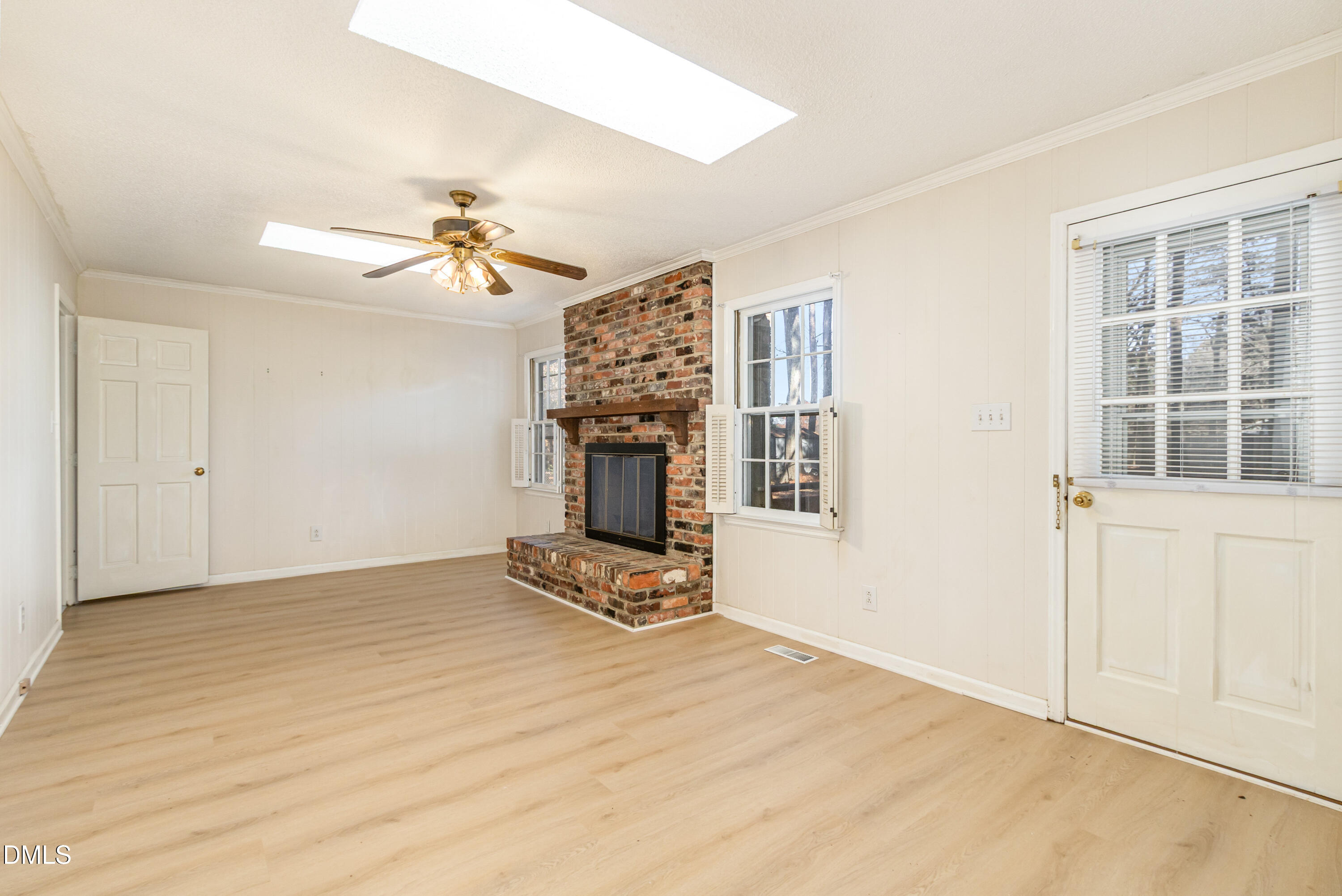 6800 Valley Drive Raleigh, NC 27612 - Photo 7 of 35 a view of an empty room with chandelier fan and wooden floor