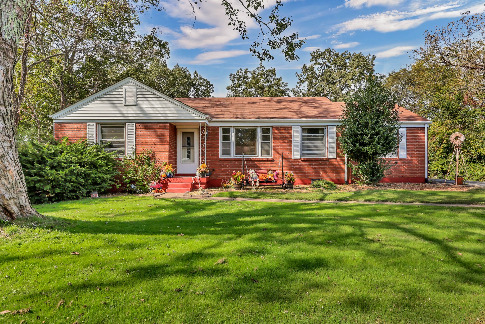 a front view of house with yard and green space