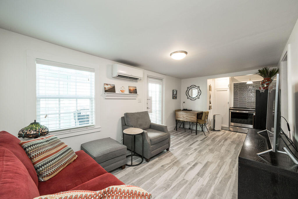 409 Margaret Street, Unit 202 Key West, FL 33040 - Photo 17 of 23 a living room with furniture and a flat screen tv