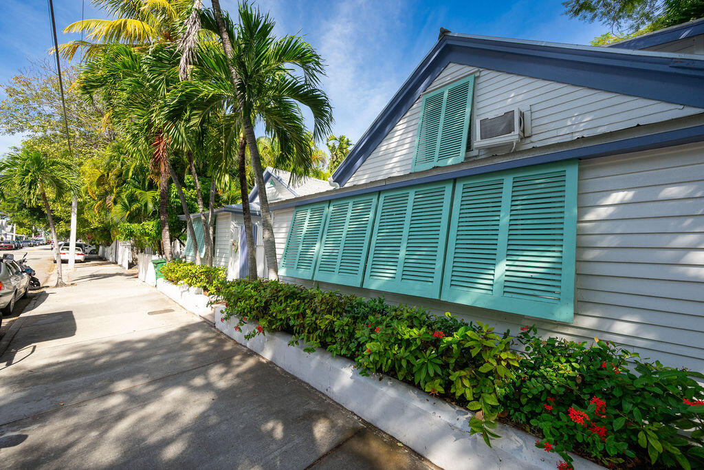 409 Margaret Street, Unit 202 Key West, FL 33040 - Photo 4 of 23 a house with a yard and potted plants