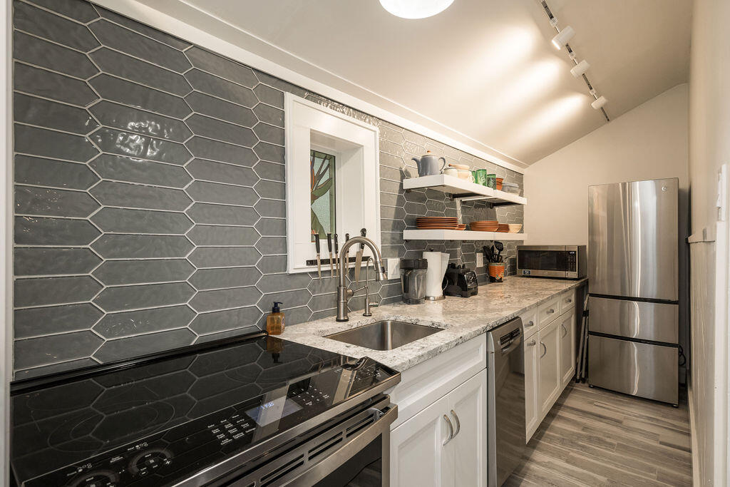 409 Margaret Street, Unit 202 Key West, FL 33040 - Photo 6 of 23 a kitchen with stainless steel appliances a sink stove and refrigerator