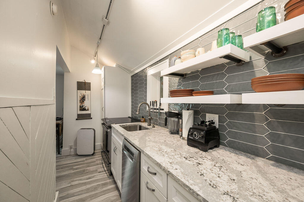 409 Margaret Street, Unit 202 Key West, FL 33040 - Photo 8 of 23 a kitchen with a sink and cabinets