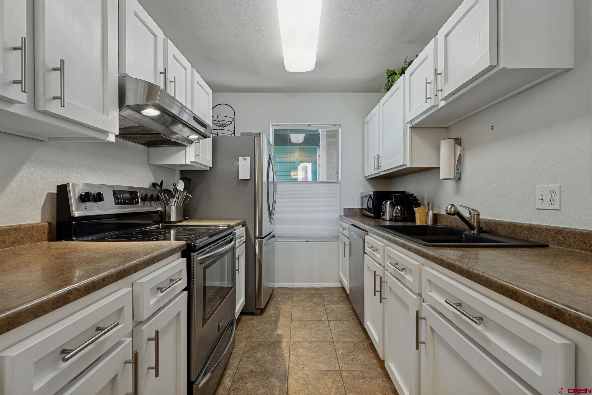 1100 Goeglein Gulch Road, Unit 225 Durango, CO 81301 - Photo 11 of 44 a kitchen with stainless steel appliances granite countertop a sink stove and cabinets