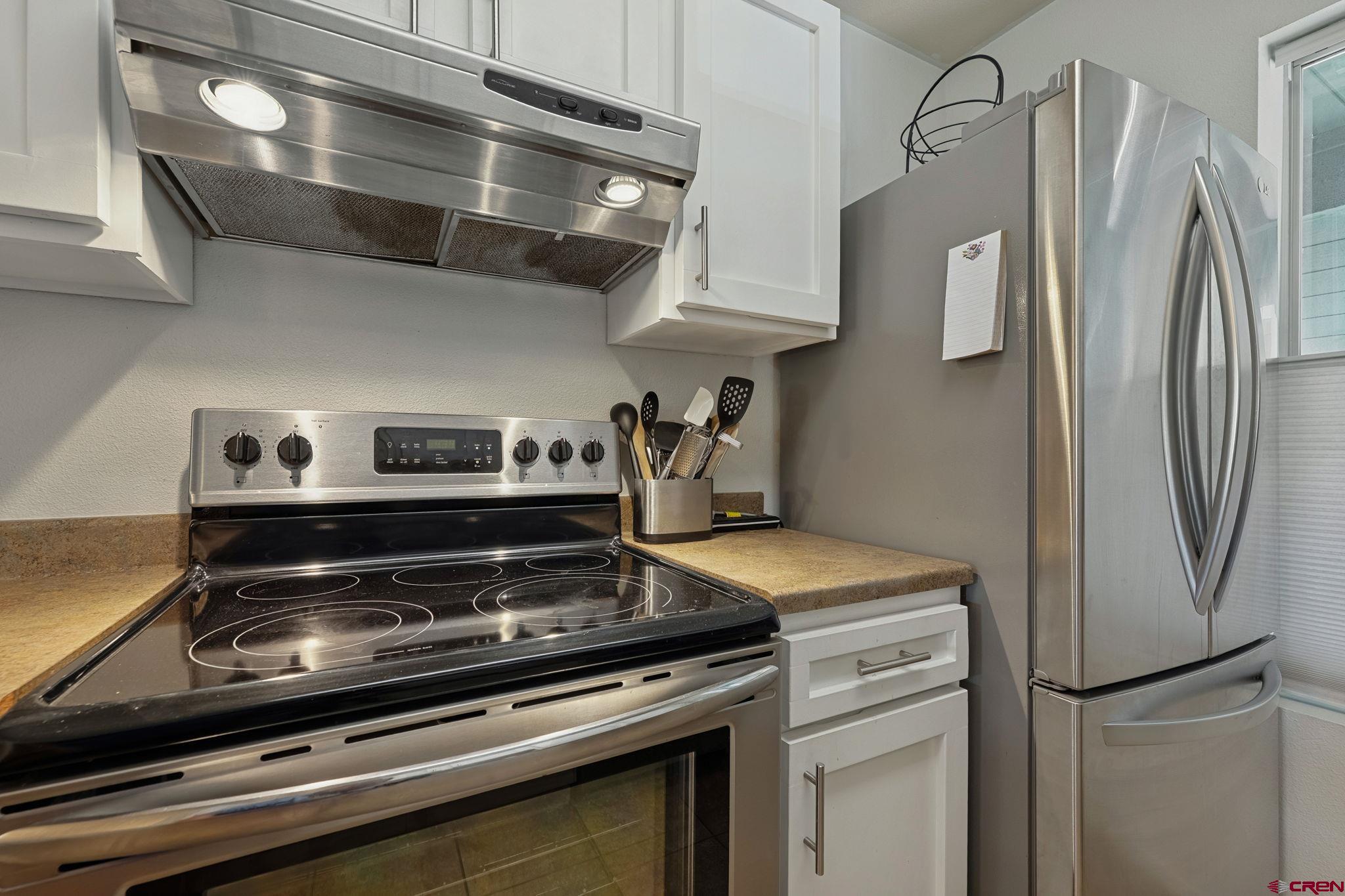 1100 Goeglein Gulch Road, Unit 225 Durango, CO 81301 - Photo 12 of 44 a stove top oven sitting inside of a kitchen