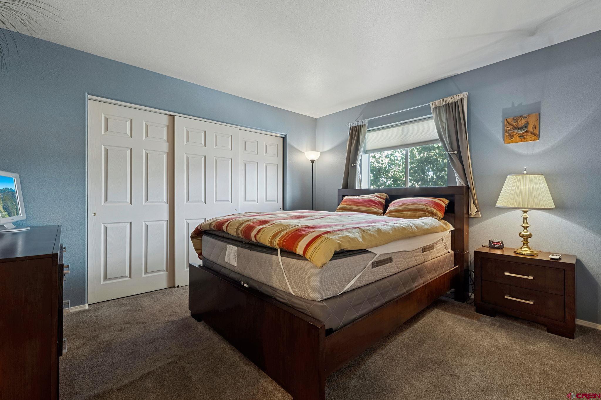 1100 Goeglein Gulch Road, Unit 225 Durango, CO 81301 - Photo 22 of 44 a bedroom with a bed and a window