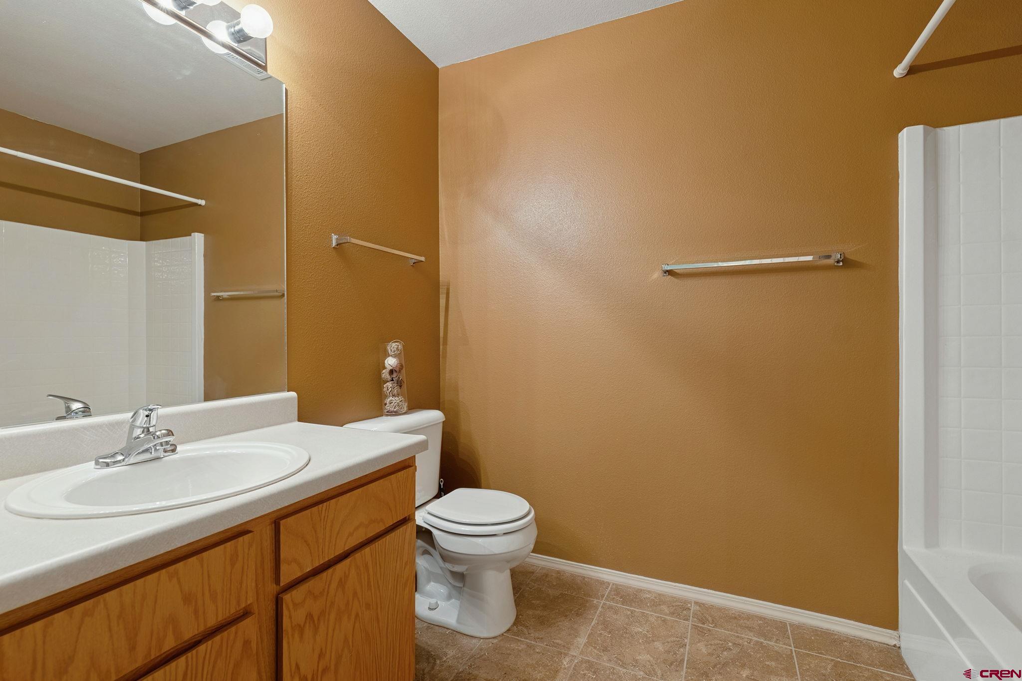 1100 Goeglein Gulch Road, Unit 225 Durango, CO 81301 - Photo 31 of 44 a bathroom with a sink a toilet and a mirror