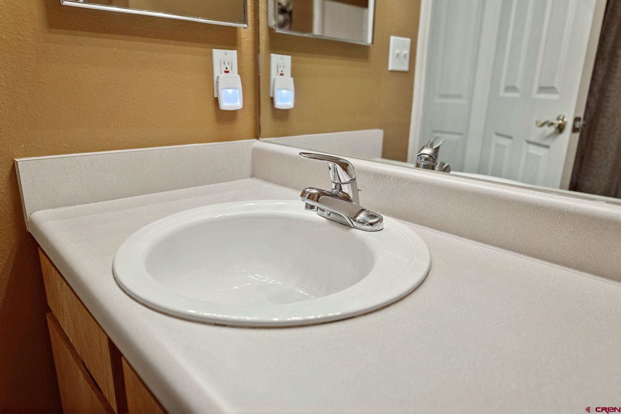 1100 Goeglein Gulch Road, Unit 225 Durango, CO 81301 - Photo 33 of 44 a bathroom with a sink and a mirror
