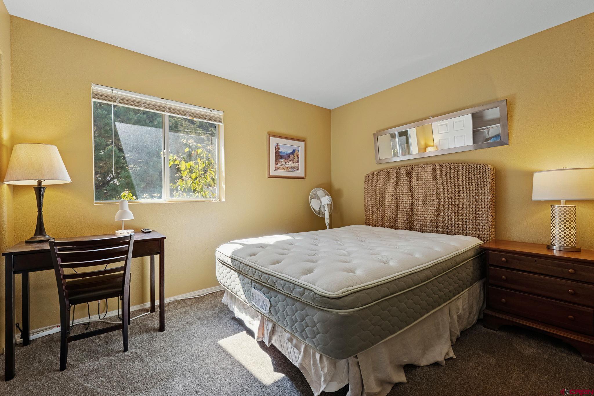 1100 Goeglein Gulch Road, Unit 225 Durango, CO 81301 - Photo 34 of 44 a bedroom with a bed and a lamp on table