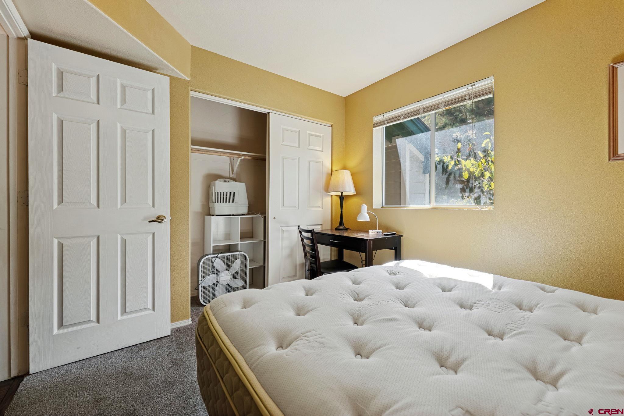 1100 Goeglein Gulch Road, Unit 225 Durango, CO 81301 - Photo 36 of 44 a bed room with a bed and a painting on the wall