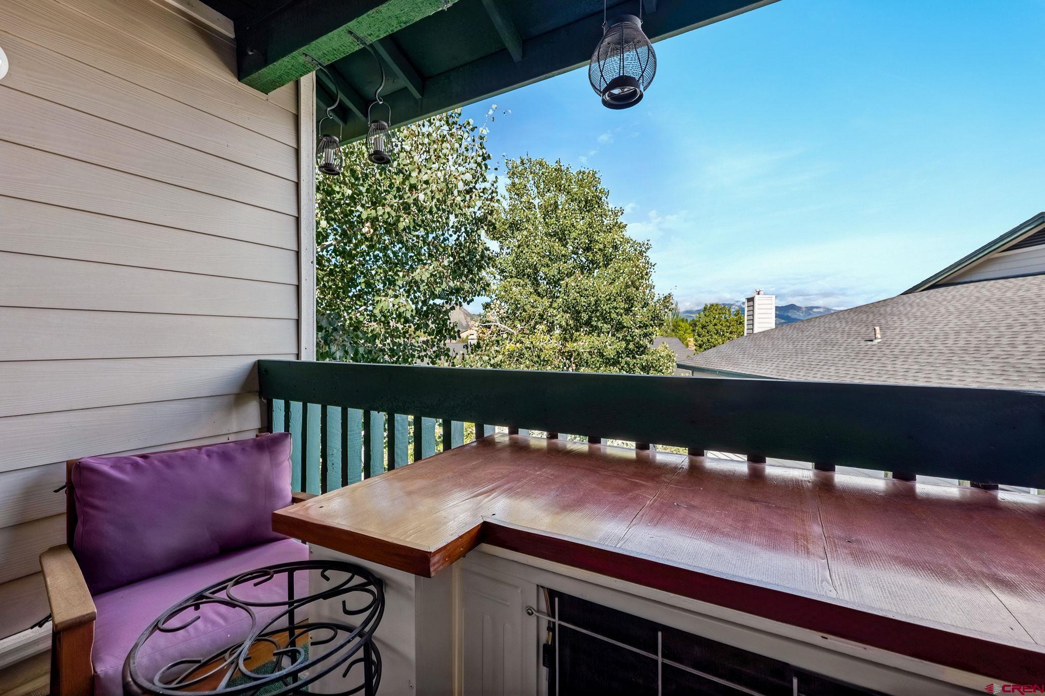 1100 Goeglein Gulch Road, Unit 225 Durango, CO 81301 - Photo 9 of 44 a view of a balcony with a table and chairs