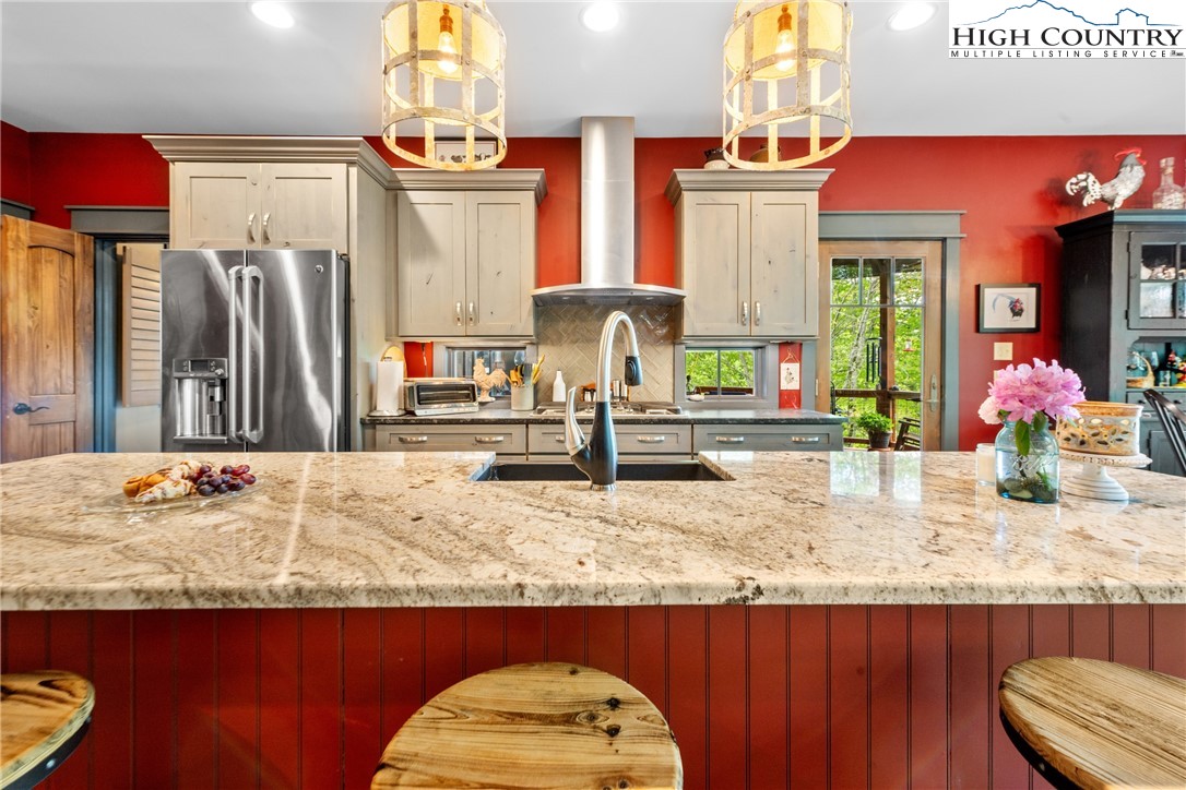 114 Preakness Boone, NC 28607 - Photo 15 of 49 a kitchen area with granite countertop a stove a sink and a dining table