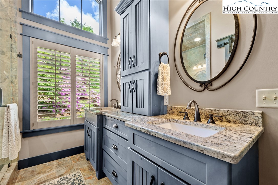 114 Preakness Boone, NC 28607 - Photo 23 of 49 a bathroom with a granite countertop sink and a mirror