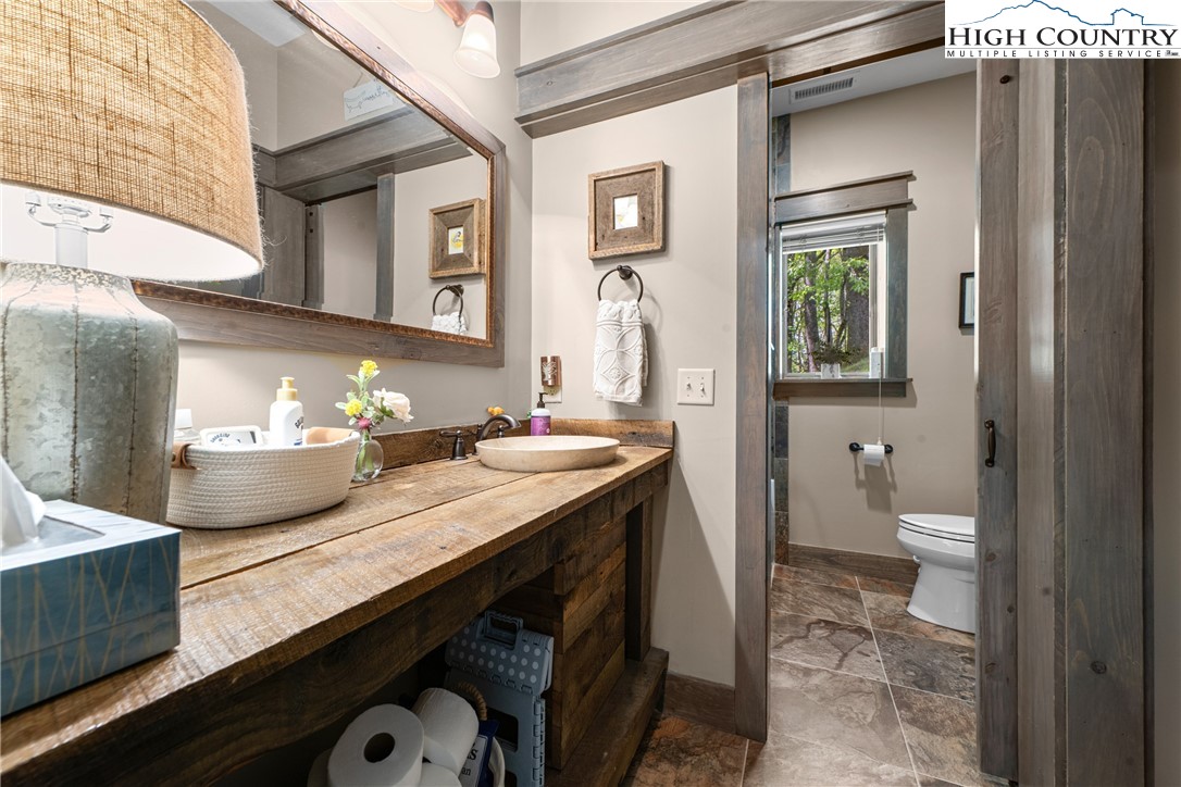 114 Preakness Boone, NC 28607 - Photo 35 of 49 a bathroom with a granite countertop sink and a toilet