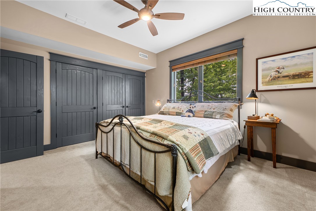 114 Preakness Boone, NC 28607 - Photo 38 of 49 a spacious bedroom with a bed and a chandelier