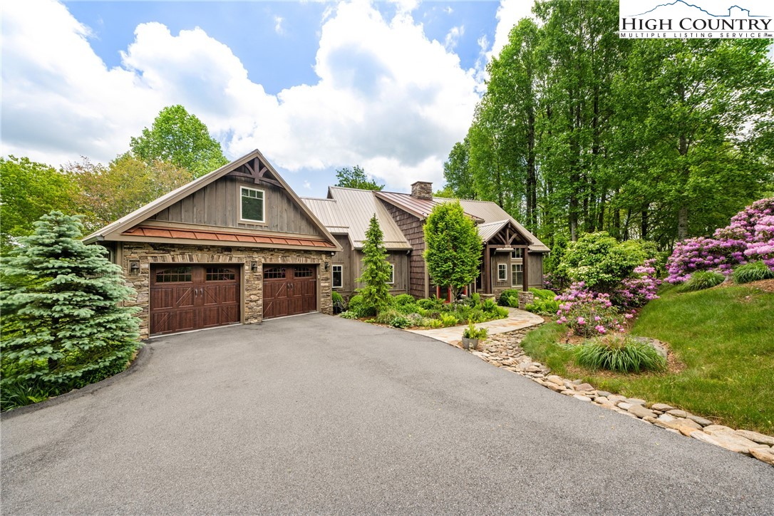 114 Preakness Boone, NC 28607 - Photo 45 of 49 a front view of a house with a garden and trees