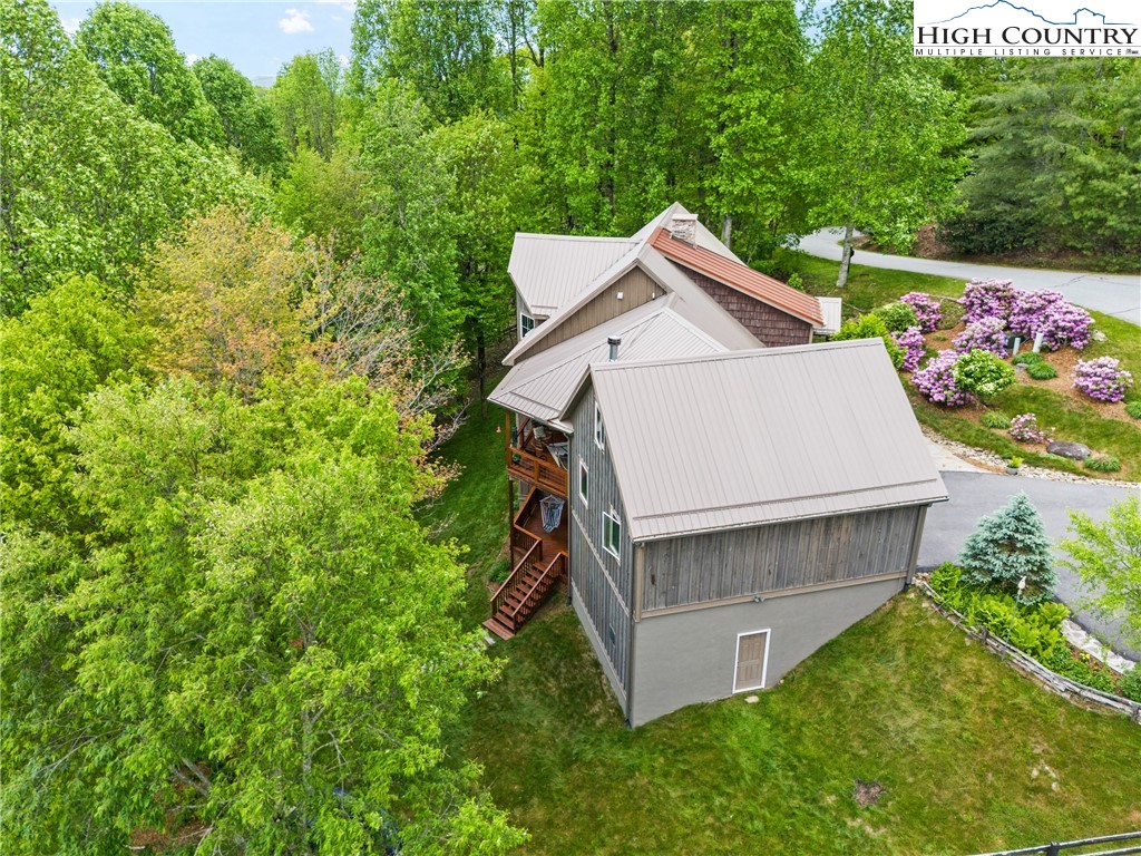 114 Preakness Boone, NC 28607 - Photo 46 of 49 a view of a wooden house with a small yard and large trees