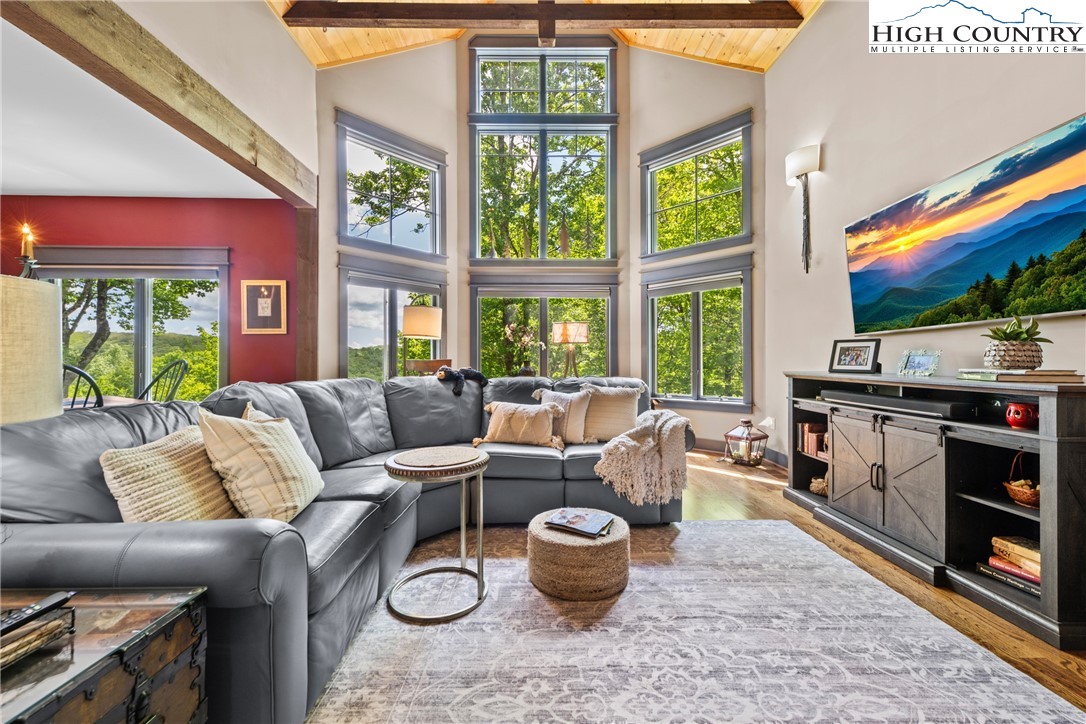 114 Preakness Boone, NC 28607 - Photo 7 of 49 a living room with furniture a flat screen tv and a floor to ceiling window