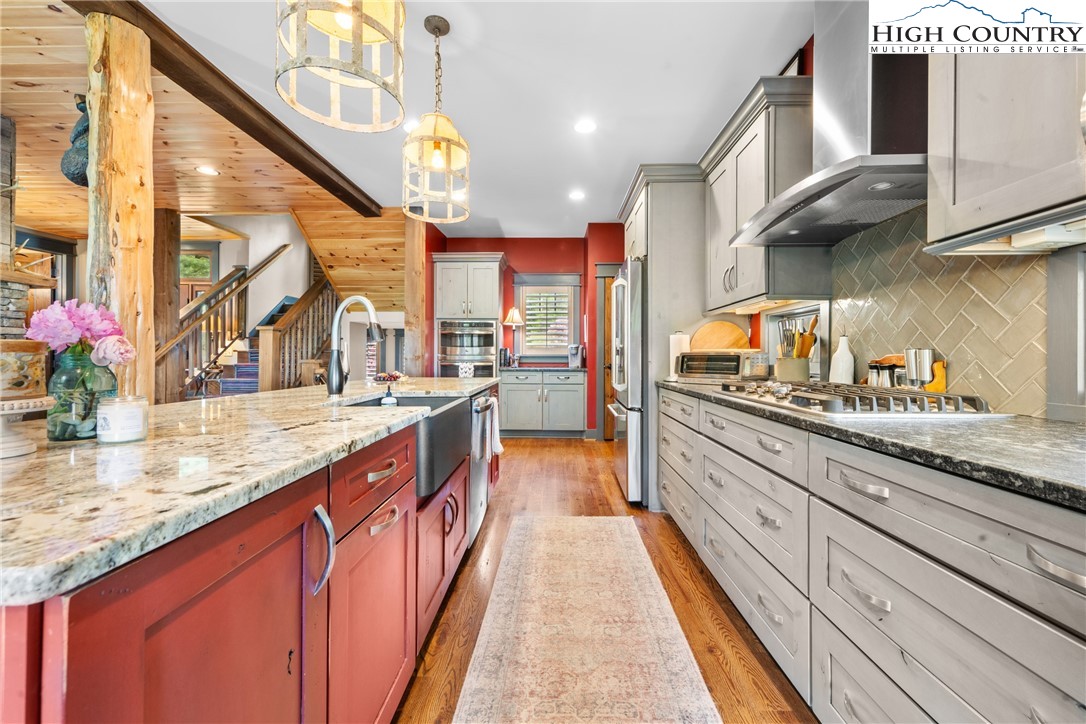 114 Preakness Boone, NC 28607 - Photo 10 of 49 a kitchen with stainless steel appliances granite countertop a sink a stove and a wooden floors