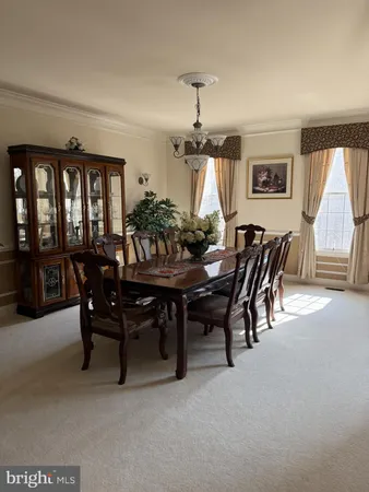 a view of a dining room with furniture and window