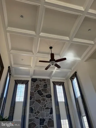 a view of a hallway with wooden floor and entryway