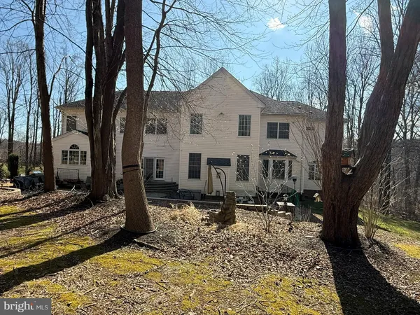 a view of a house with a yard covered in snow