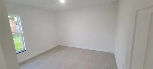 a bathroom with a granite countertop toilet and a sink