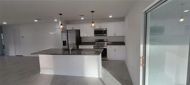 a view of a kitchen with a sink and a stove top oven