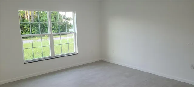 a view of an empty room and a window