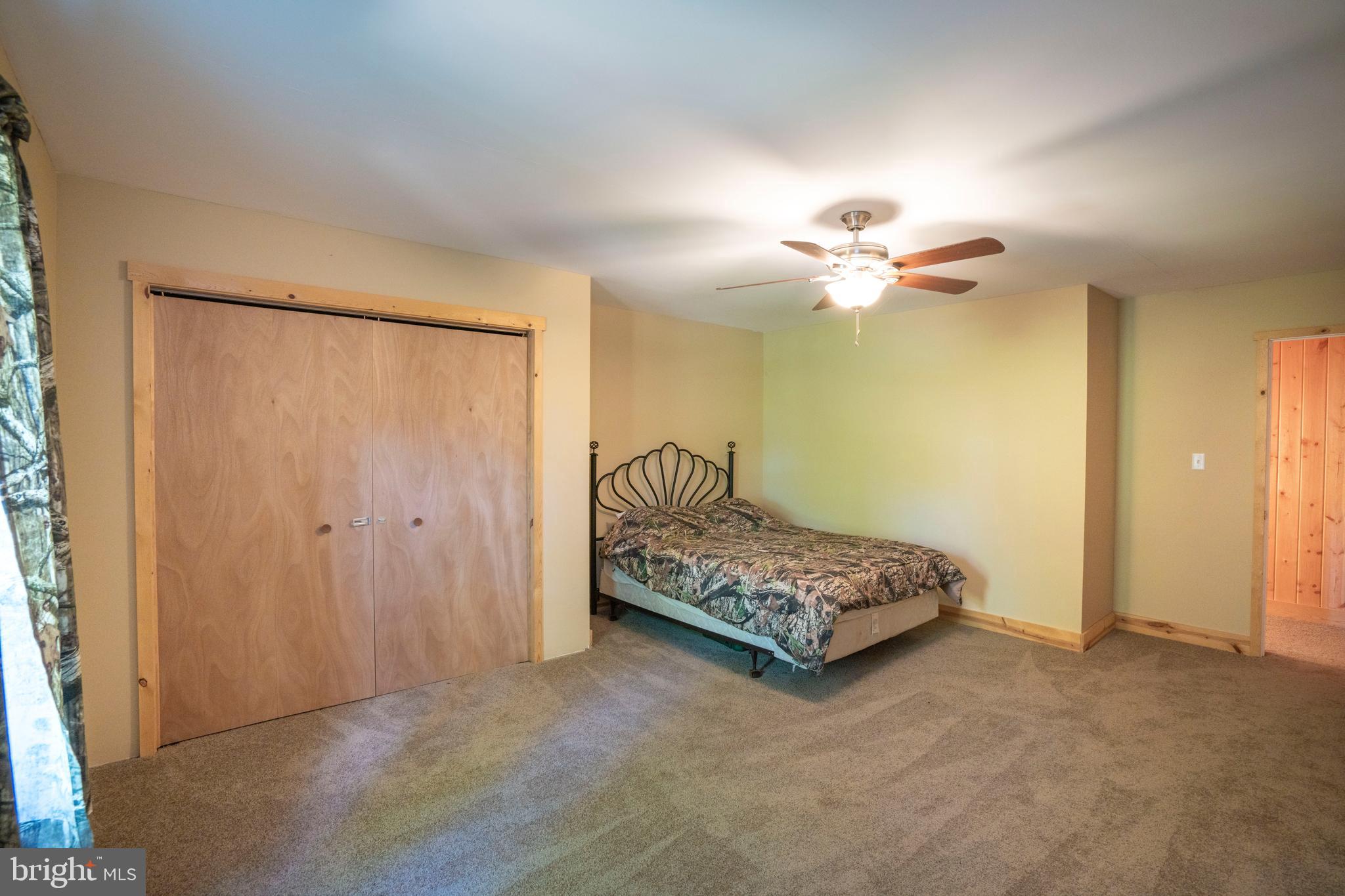 385 Elk Creek Road Aaronsburg, PA 16820 - Photo 43 of 71 a bedroom with a bed and a chandelier