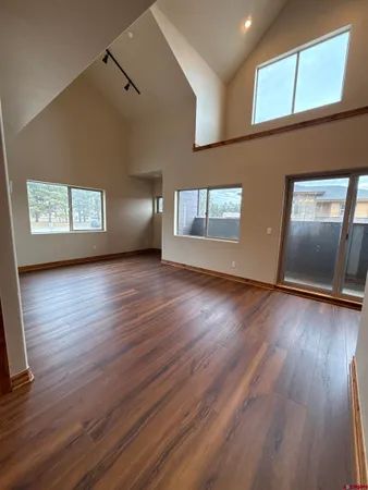 a view of a livingroom with wooden floor and window