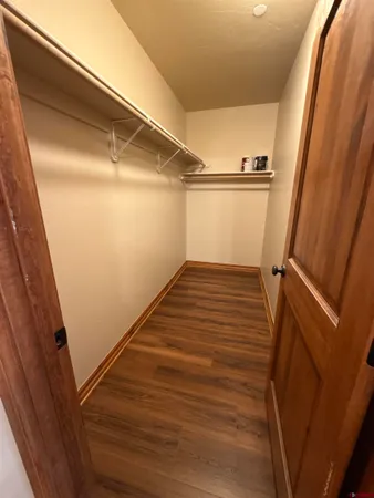 a view of a room with wooden floor and staircase