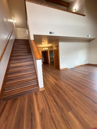 wooden floor in an empty room with stairs