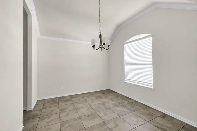 an empty room with a ceiling fan and window